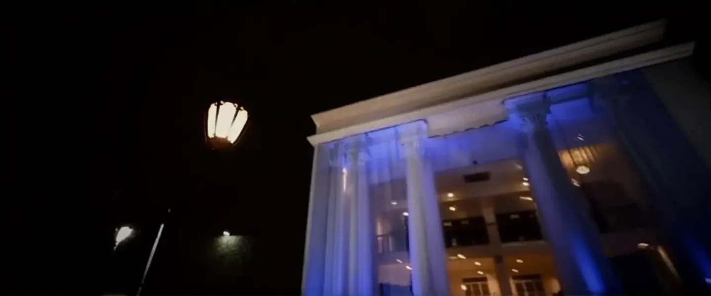OSMO's colonial facade lit blue at night